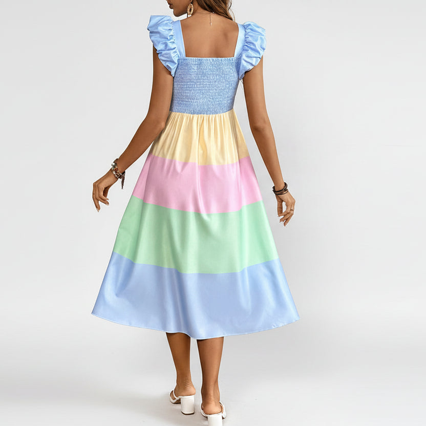 Woman wearing a colorful dress with a wooden cabinet and decorative items in the background