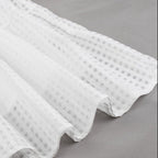 White textured fabric on a gray background