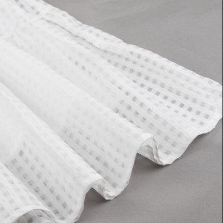 White textured fabric on a gray background